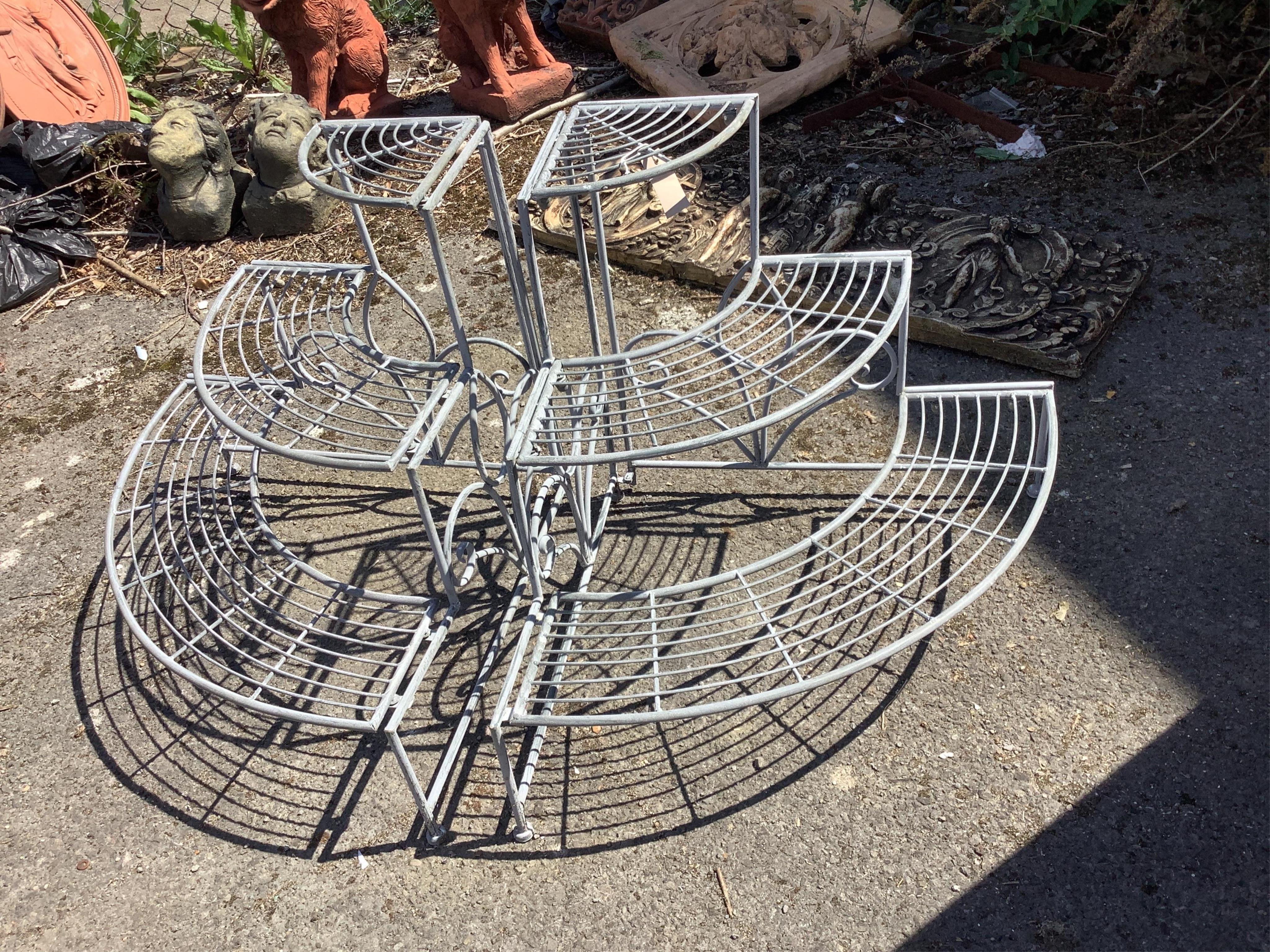 A pair of Victorian style painted metal three tier corner pot stands, each width 83cm, depth 59cm, height 60cm